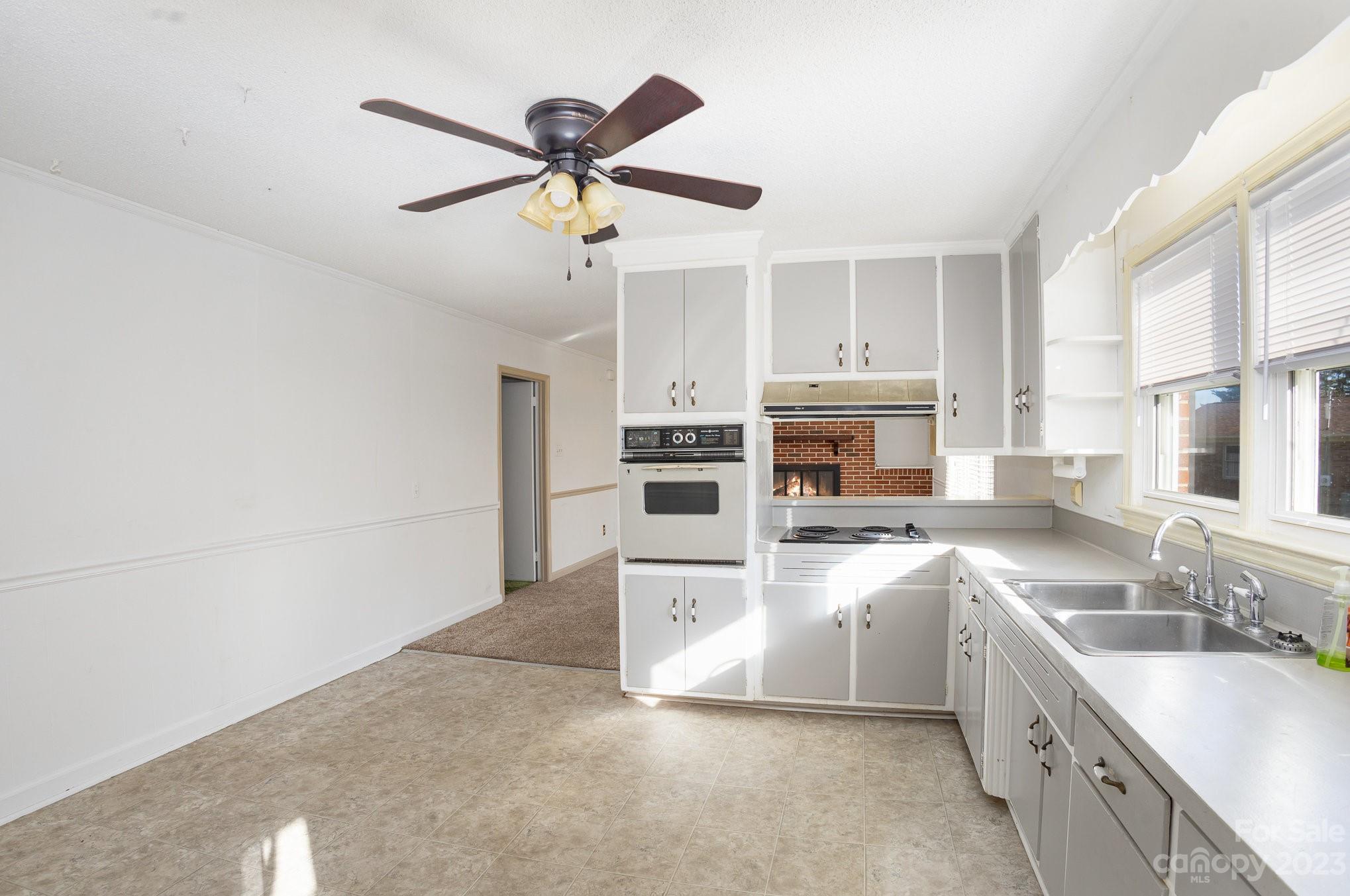 408 Jane Street Cherryville, NC 28021 - Photo 4 of 15 a large kitchen with stainless steel appliances granite countertop a sink and cabinets