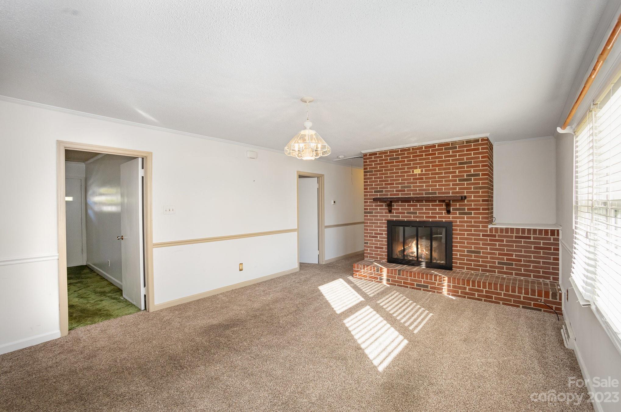 408 Jane Street Cherryville, NC 28021 - Photo 6 of 15 a view of livingroom with fireplace window and fireplace