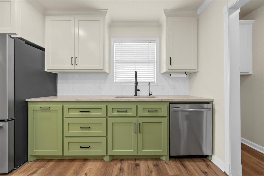 4401 Lacey Circle Waco, TX 76708 - Photo 13 of 38 a kitchen with cabinets a sink and a window