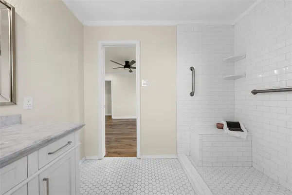a bathroom with a granite countertop sink a toilet and shower