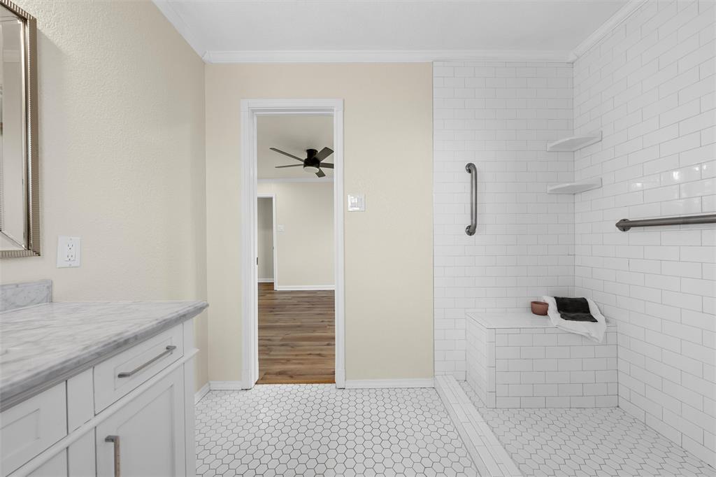 4401 Lacey Circle Waco, TX 76708 - Photo 19 of 38 a bathroom with a granite countertop sink a toilet and shower