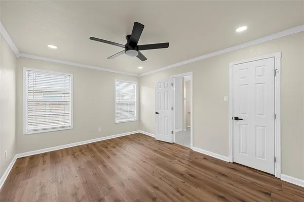 a view of empty room with wooden floor and window