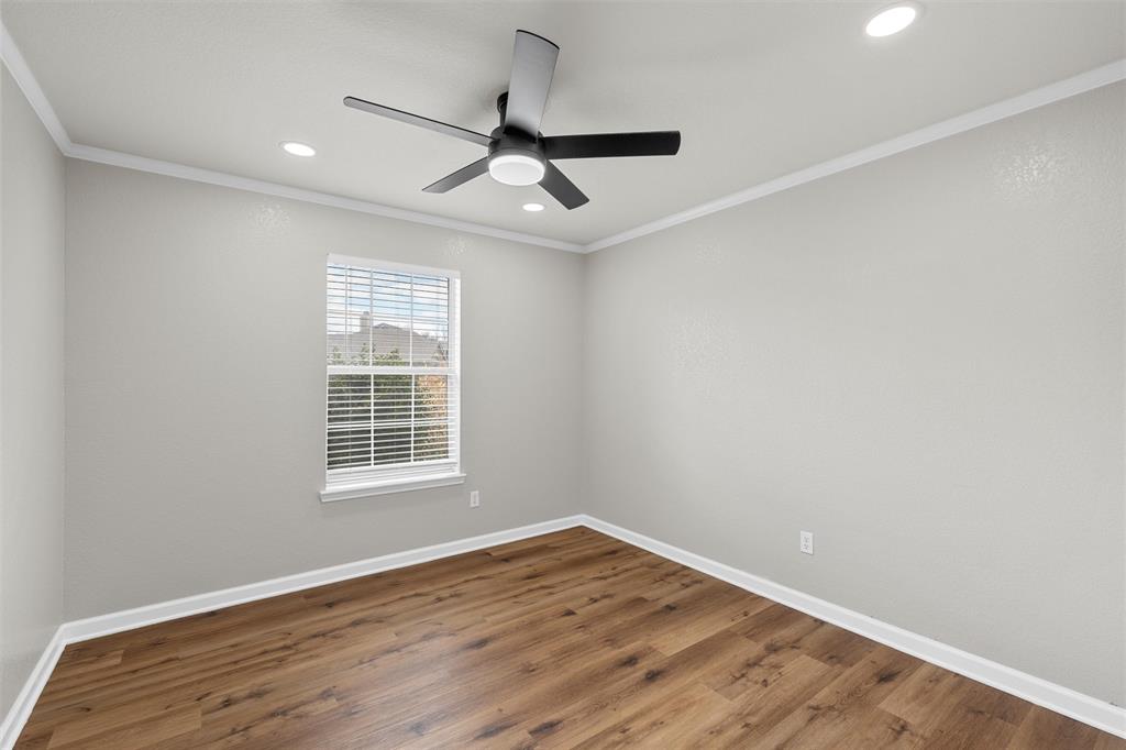 4401 Lacey Circle Waco, TX 76708 - Photo 26 of 38 an empty room with wooden floor fan and windows