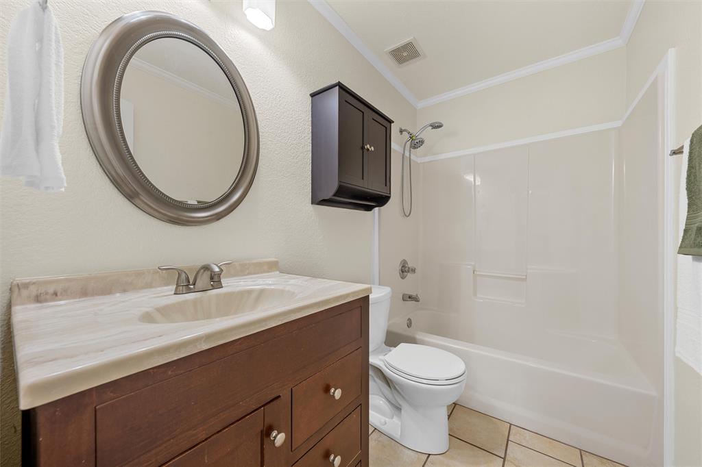 4401 Lacey Circle Waco, TX 76708 - Photo 27 of 38 a bathroom with a sink a toilet and a mirror