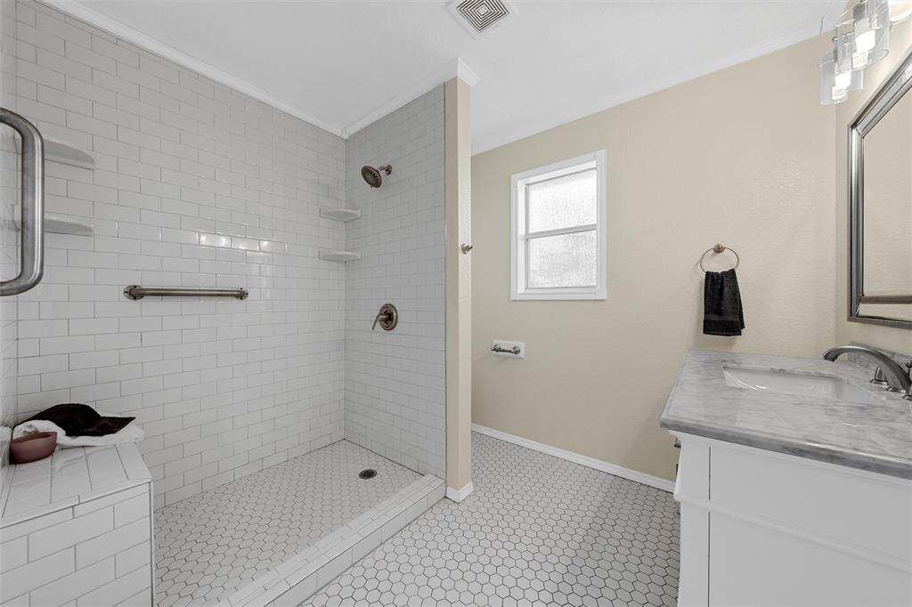 4401 Lacey Circle Waco, TX 76708 - Photo 30 of 38 a bathroom with a granite countertop sink a shower and mirror