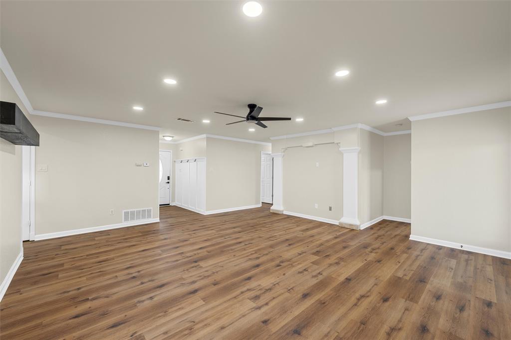 4401 Lacey Circle Waco, TX 76708 - Photo 8 of 38 a view of an empty room with wooden floor and a ceiling fan