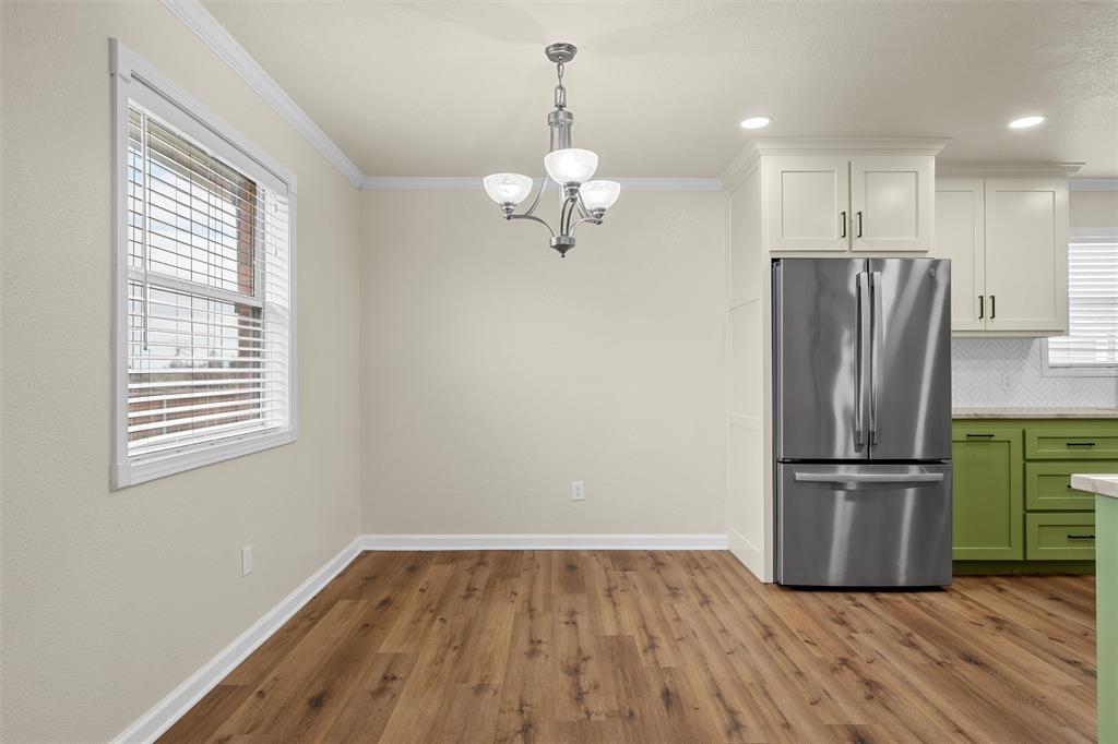 4401 Lacey Circle Waco, TX 76708 - Photo 9 of 38 a kitchen with a refrigerator and wooden floor