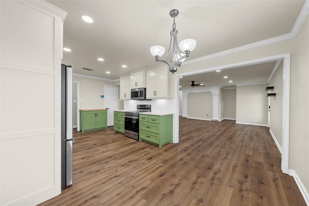 4401 Lacey Circle Waco, TX 76708 - Photo 10 of 38 a open kitchen with stainless steel appliances granite countertop a refrigerator a oven a sink and a dining table with wooden floor