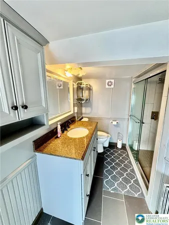 a bathroom with a shower and a mirror