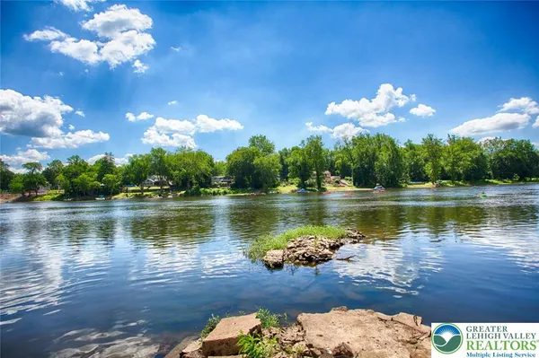 a small pool with some trees in the background