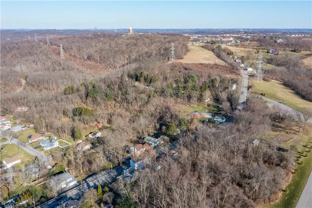 an aerial view of house with yard and mountain in the background