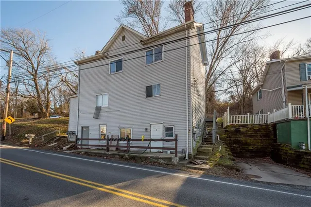 a view of a street that has a car parked on the road