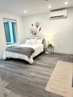 a spacious bedroom with a bed and a large mirror