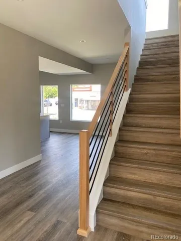 a view of entryway and hall with wooden floor