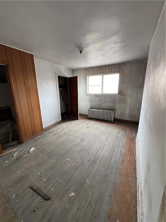 72 Harlem Avenue McKees Rocks, PA 15136 - Photo 3 of 6 an empty room with wooden floor and windows