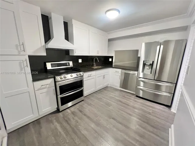 a kitchen with stainless steel appliances a refrigerator and a stove