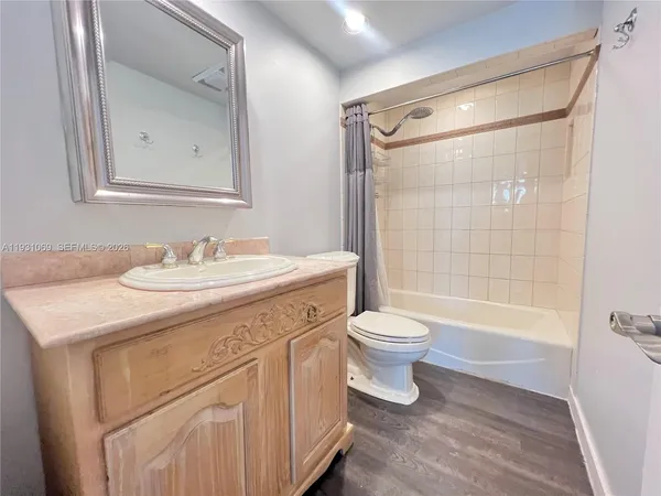 an empty room with wooden floor and closet