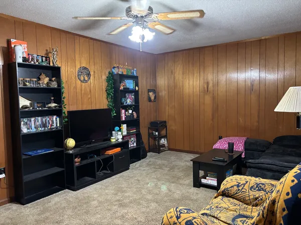 a bedroom with furniture and a mirror