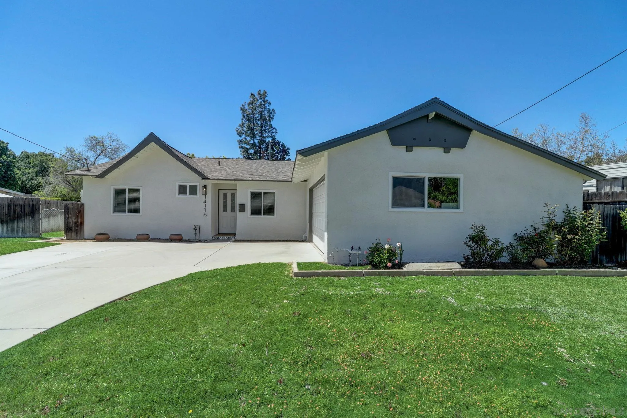 14116 Powers Road Poway, CA 92064 - Photo 3 of 63 a front view of a house with a yard
