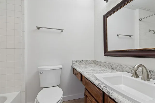 an empty room with wooden floor & closet area