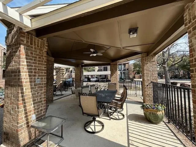 a view of a patio with table and chairs