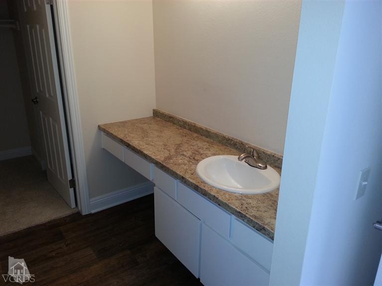 1754 Sinaloa Road, Unit 276 Simi Valley, CA 93065 - Photo 13 of 13 a bathroom with a granite countertop sink and a mirror