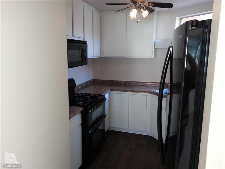 1754 Sinaloa Road, Unit 276 Simi Valley, CA 93065 - Photo 4 of 13 a kitchen with a refrigerator stove and a sink