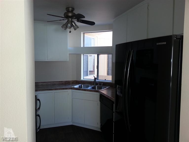 1754 Sinaloa Road, Unit 276 Simi Valley, CA 93065 - Photo 6 of 13 a kitchen with a sink a refrigerator and cabinets