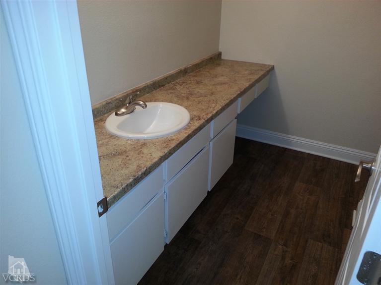 1754 Sinaloa Road, Unit 276 Simi Valley, CA 93065 - Photo 9 of 13 a bathroom with a granite countertop sink and a mirror