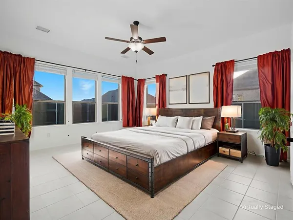 a bedroom with a large bed and a chandelier