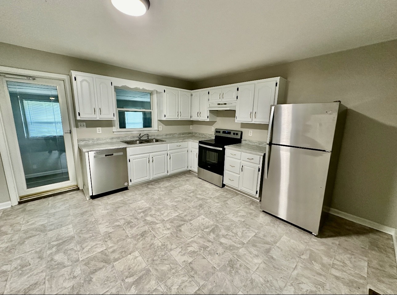 1445 Old Lascassas Road Murfreesboro, TN 37130 - Photo 3 of 18 a kitchen with stainless steel appliances granite countertop a refrigerator a stove a sink a microwave and cabinets