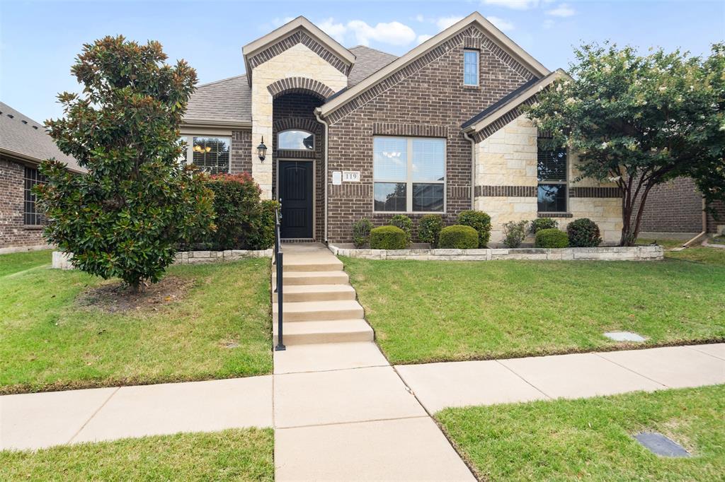 119 Happy Lane Red Oak, TX 75154 - Photo 1 of 37 Brick and stone facade featuring an arched entryway with a dark-paneled front door