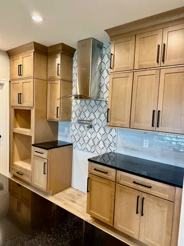 a kitchen with stainless steel appliances granite countertop a sink and a refrigerator