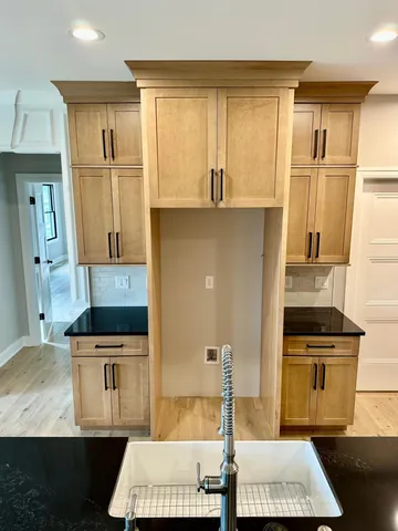 a kitchen with kitchen island granite countertop a sink stove and refrigerator
