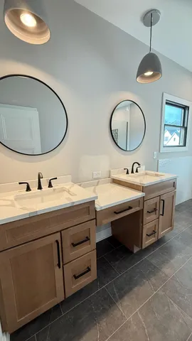 a bathroom with a double vanity sink and a mirror