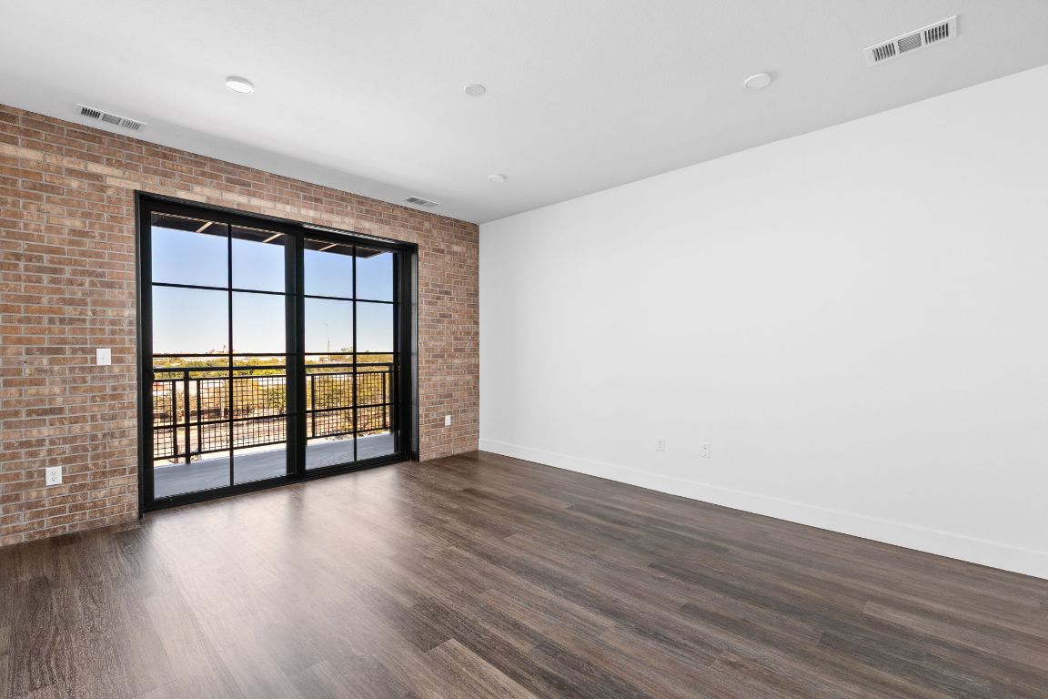 4315 South Congress Avenue, Unit 527 Austin, TX 78745 - Photo 4 of 37 wooden floor in an empty room with a window