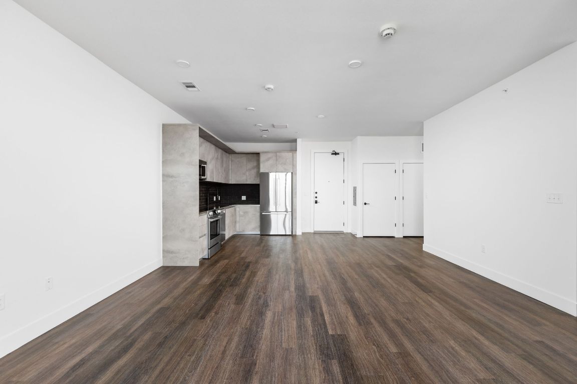 4315 South Congress Avenue, Unit 527 Austin, TX 78745 - Photo 5 of 37 a view of empty room with wooden floor