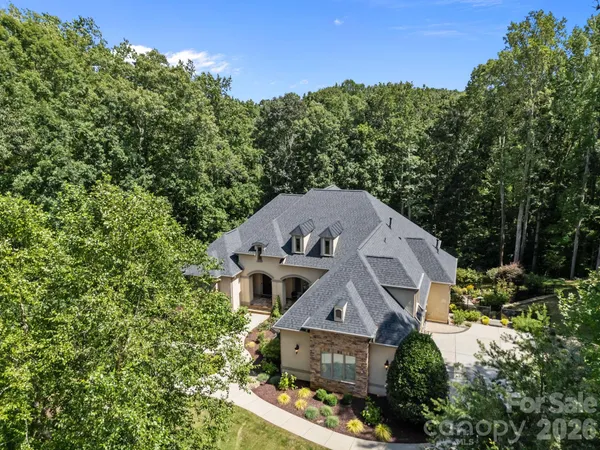 an aerial view of a house with a yard
