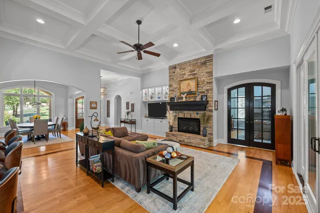 a living room with furniture a fireplace and a chandelier