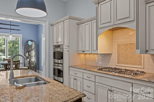 a kitchen with a refrigerator and a sink