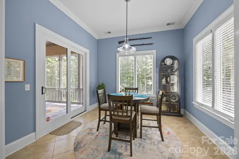 an empty room with windows and ceiling fan