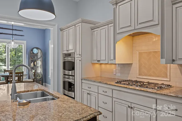 a kitchen with a refrigerator and a sink