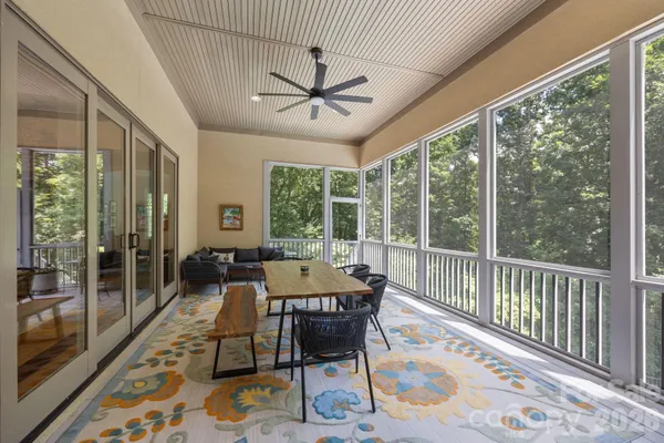 a dining room with wooden floor and a rug