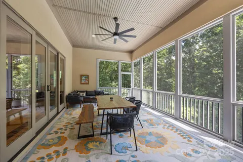 a dining room with wooden floor and a rug