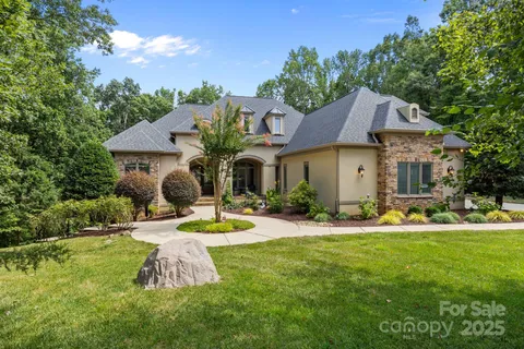 a view of a house with swimming pool and yard