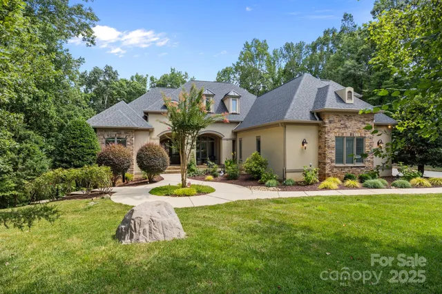 a view of a house with swimming pool and yard