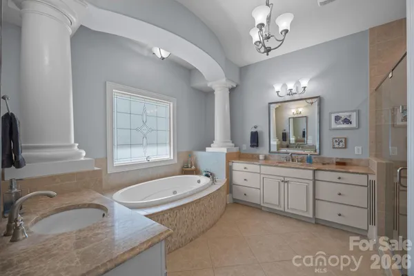 a bathroom with a granite countertop sink mirror and bathtub