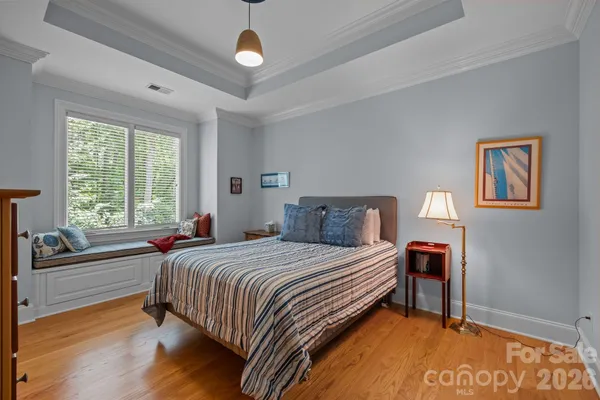 a bedroom with a bed and a large window