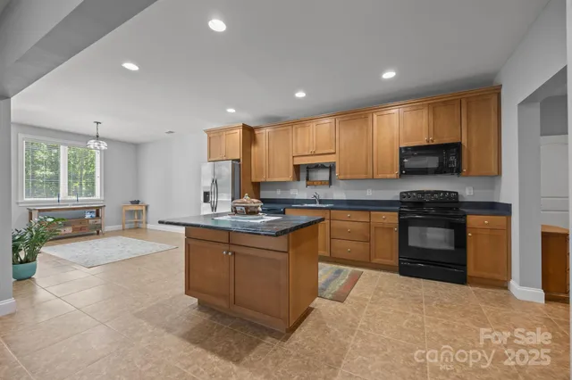 a kitchen with granite countertop a stove sink and cabinets