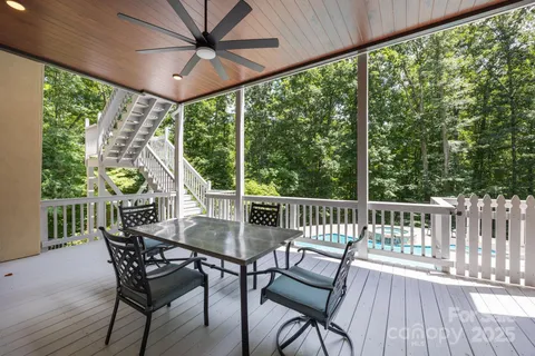 a view of a porch with furniture and wooden floor